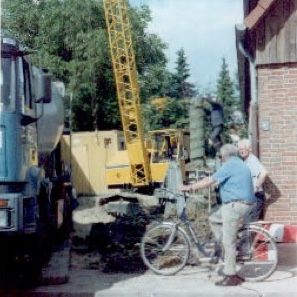 Man on bicycle looking at construction